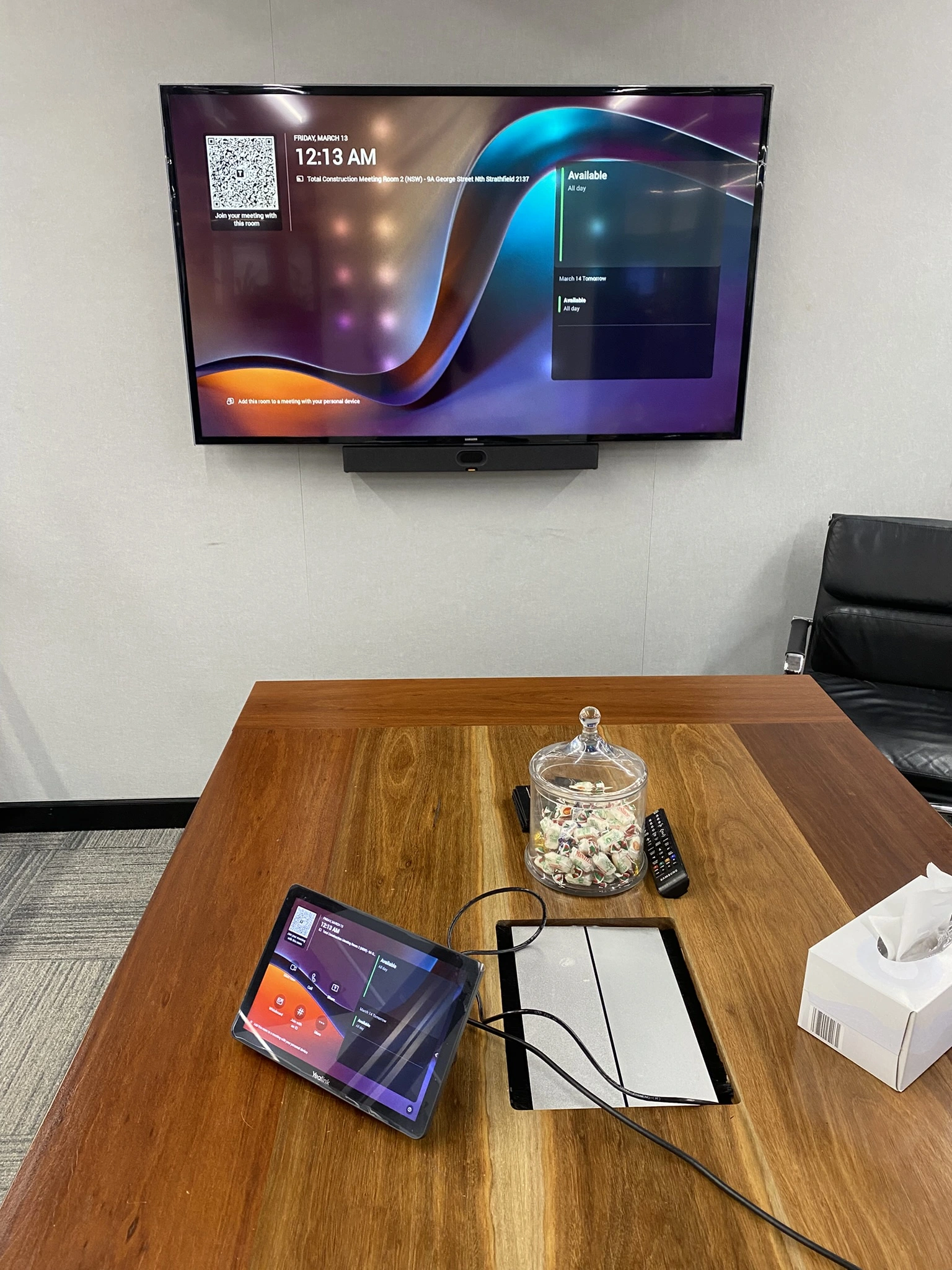 Commercial boardroom display Teams Room mounted above a meeting table